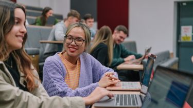 Students working together in a lecture theatre.